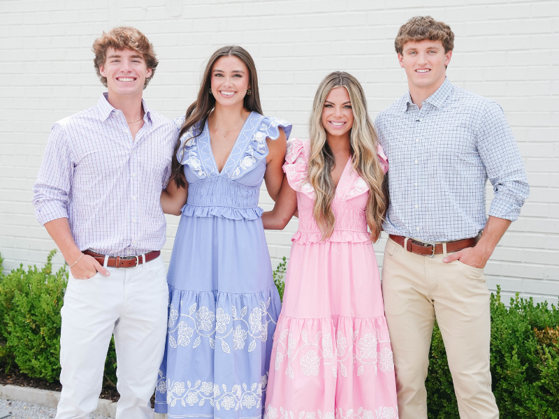 Group of friends wearing coordinated Easter outfits with pastel maxi dresses, ruffle sleeves, and classic button-down shirts.