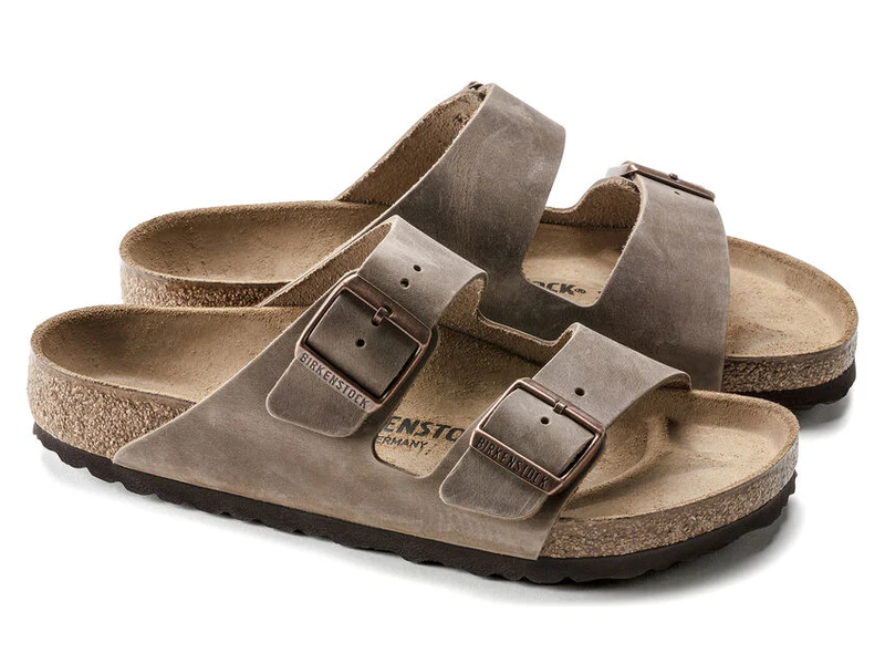 a pair of brown birkinstock sandals on a white background