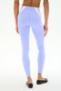 A model shown from the back wearing light periwinkle purple leggings with white side panels and black ballet flats, set against a plain white studio background.