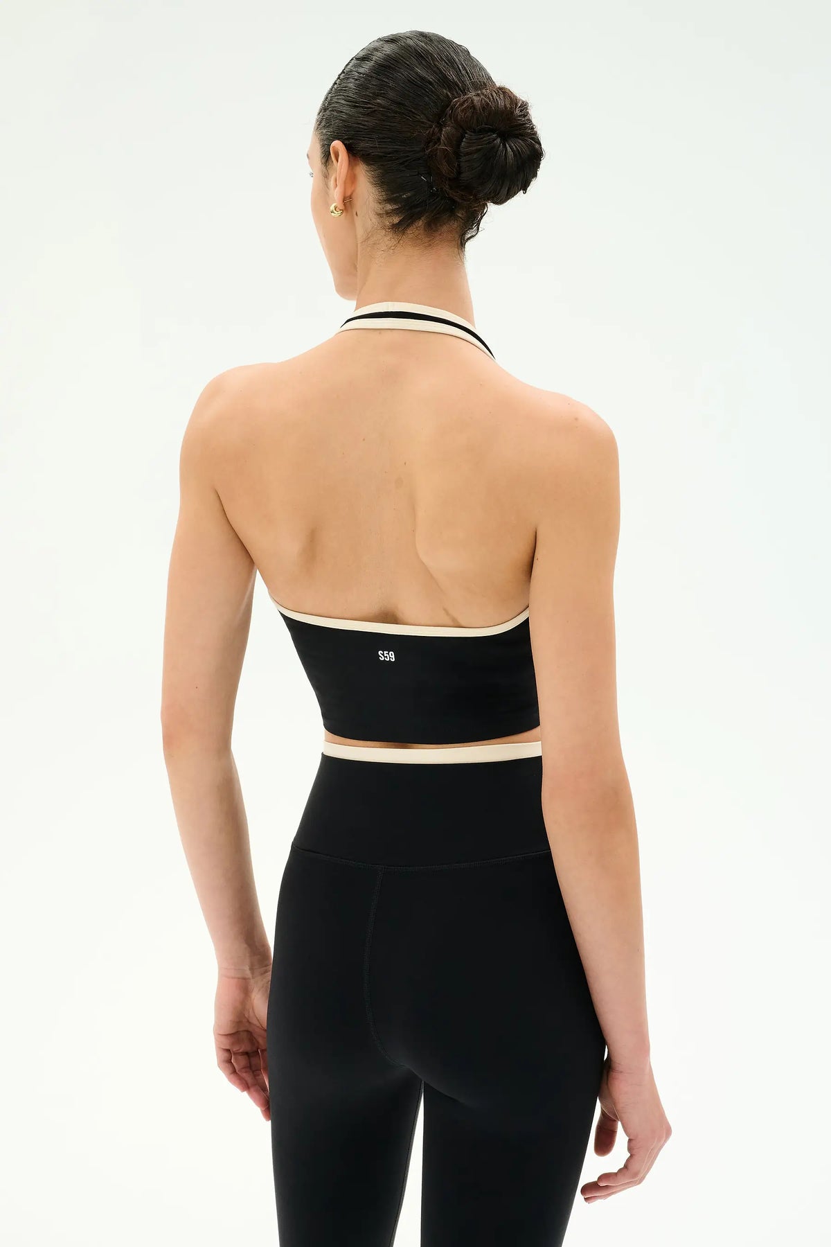 woman standing facing backwards modeling a halter athletic top
