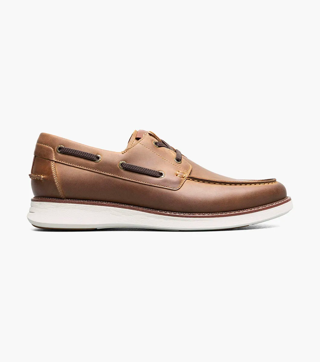 Brown leather boat shoe on a white background
