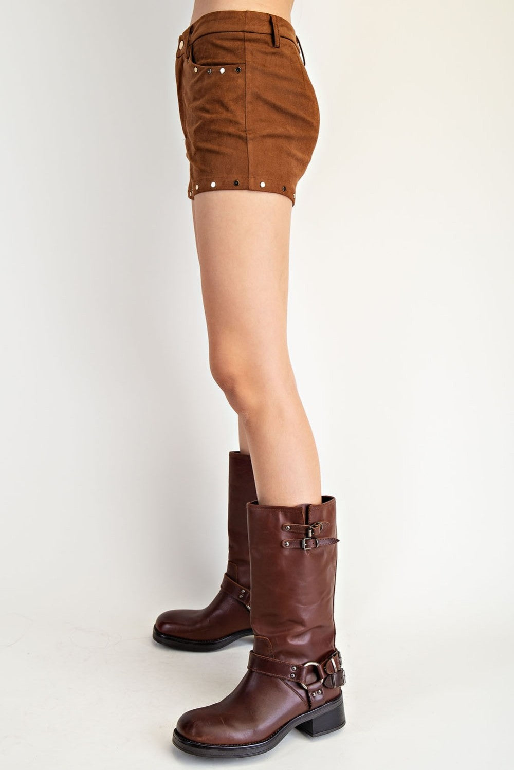 Brown leather boots and shorts on a white background