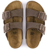 Brown Birkenstock sandals with gold buckle on a white background