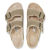 Pair of beige sandals with fur lining on a white background