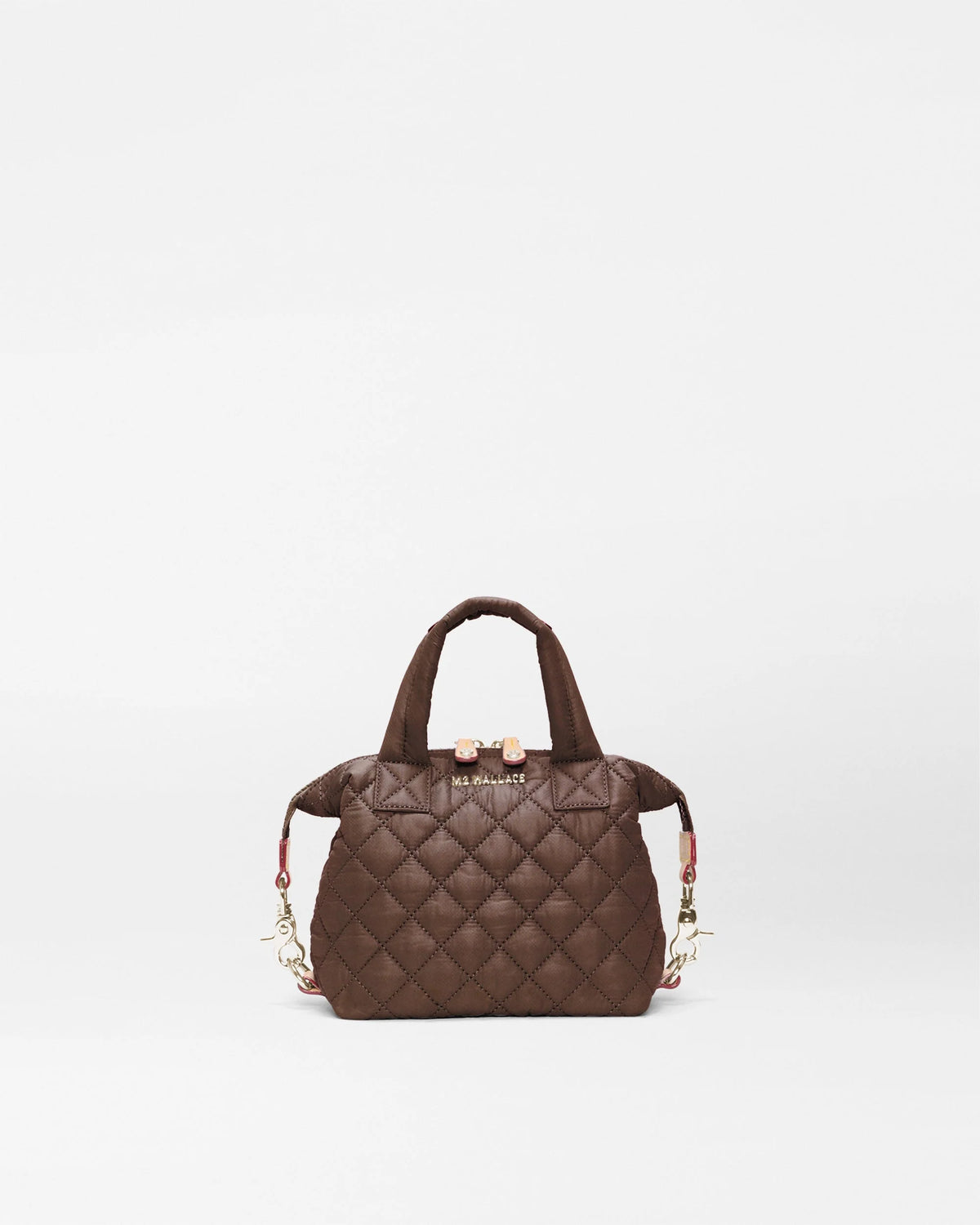 A dark brown quilted leather handbag with top handles and a small gold-tone logo plaque on the front, photographed against a clean white background.