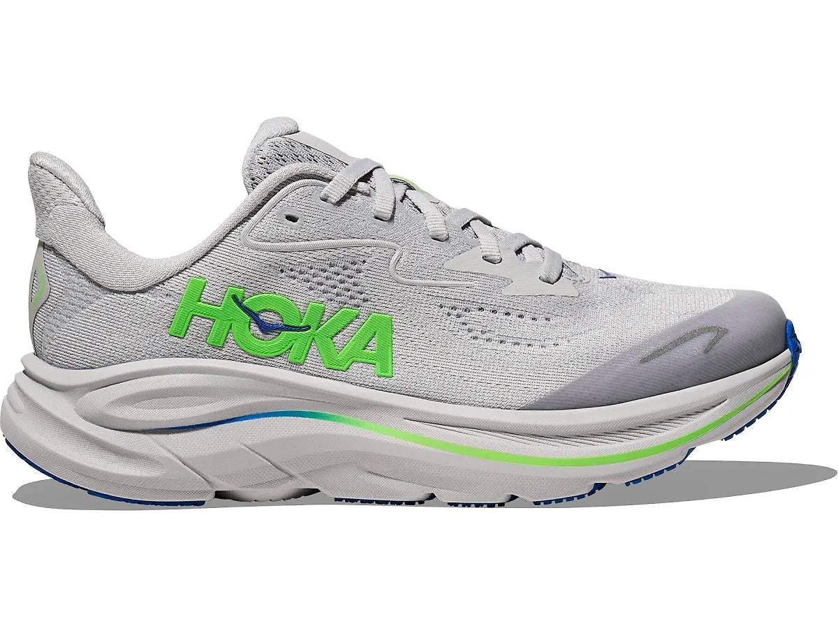 A Hoka running shoe in light gray and white with bright green logo accents and a small blue accent on the midsole and outsole, shown against a plain white background.