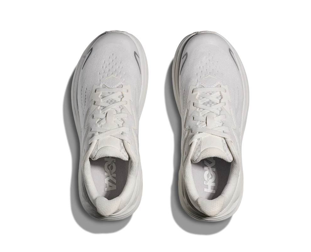 A pair of white Hoka running shoes shown from a top-down view on a clean white background with soft drop shadows.