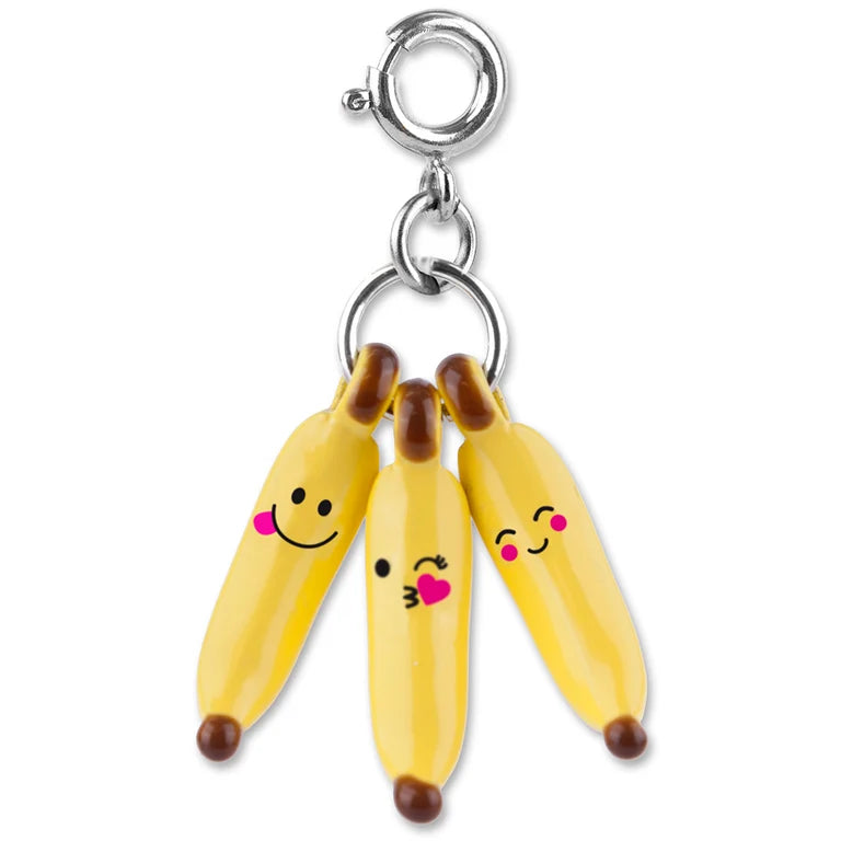 Banana charm with smiley faces on a white background