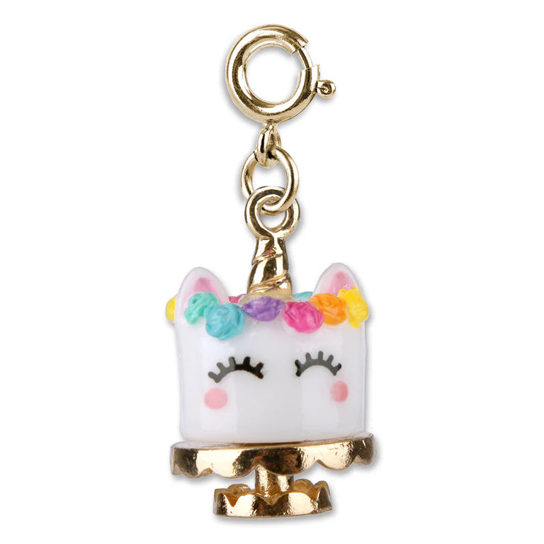 A gold-plated unicorn charm with a white face, closed black eyelashes, pink cheeks, and a colorful floral crown, hanging from a gold clasp on a white background.