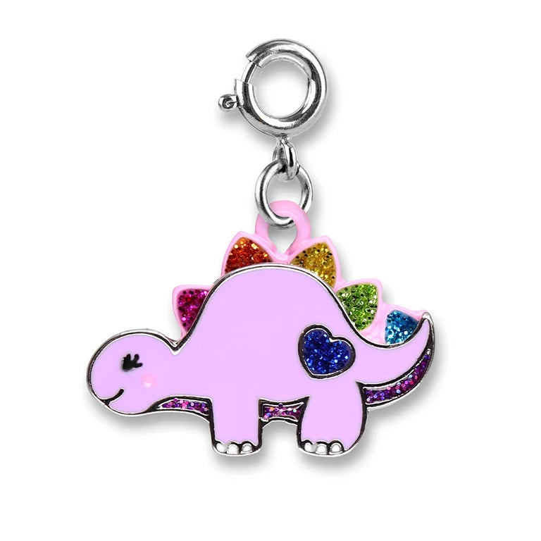 A pink dinosaur charm with glittery rainbow spikes and a blue heart on its side, attached to a silver lobster clasp on a white background.