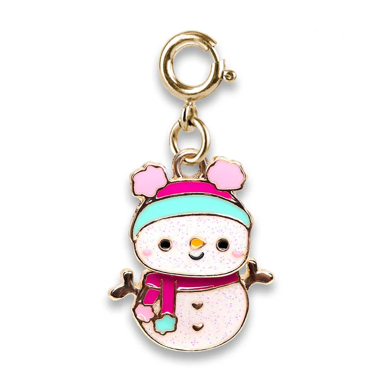 A gold-tone snowman charm with a pink and mint blue hat, pink scarf, and glittery white body, shown on a plain white background.