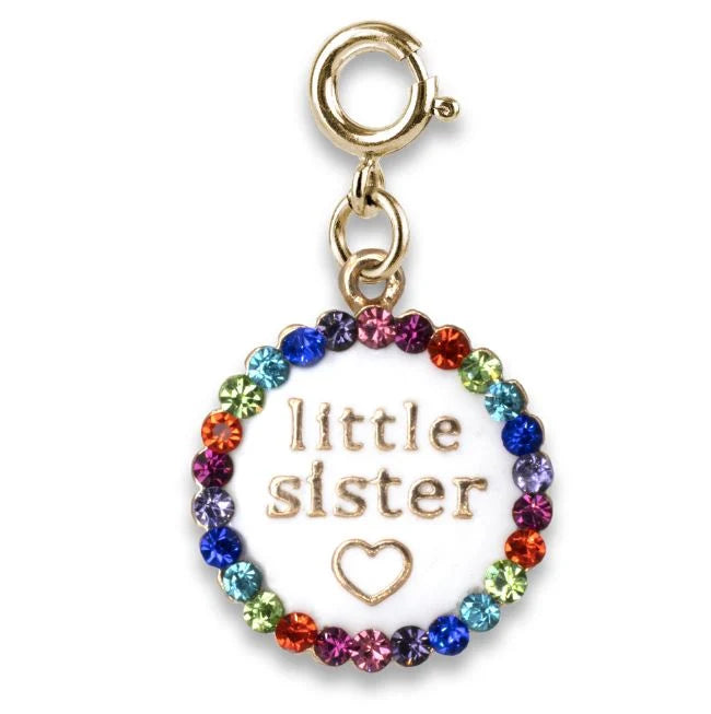 Gold charm with 'little sister' and heart text surrounded by colorful crystals on a white background