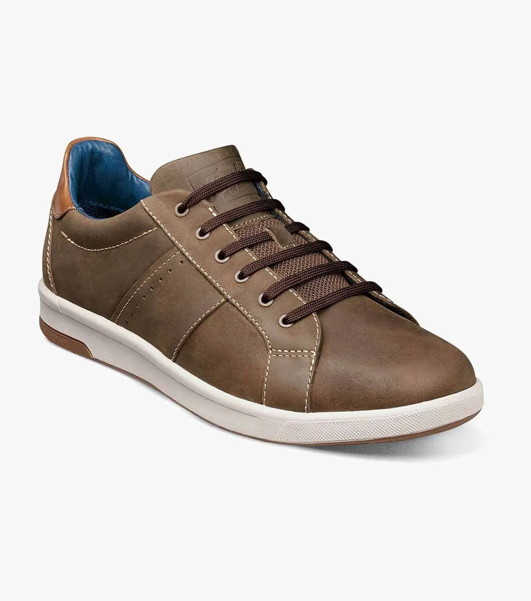 Brown leather sneaker with white sole on a light gray background