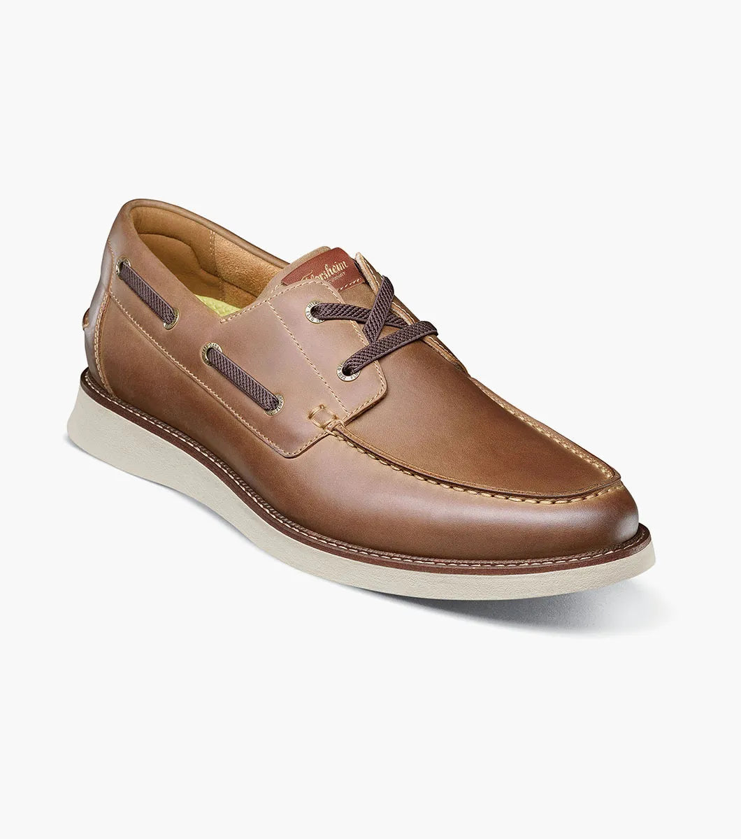 Brown leather boat shoe on a white background