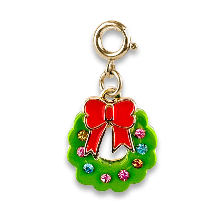 A gold-tone holiday wreath charm with a bright green enamel base, a red bow at the top, and small multicolored rhinestones, shown on a plain white background.