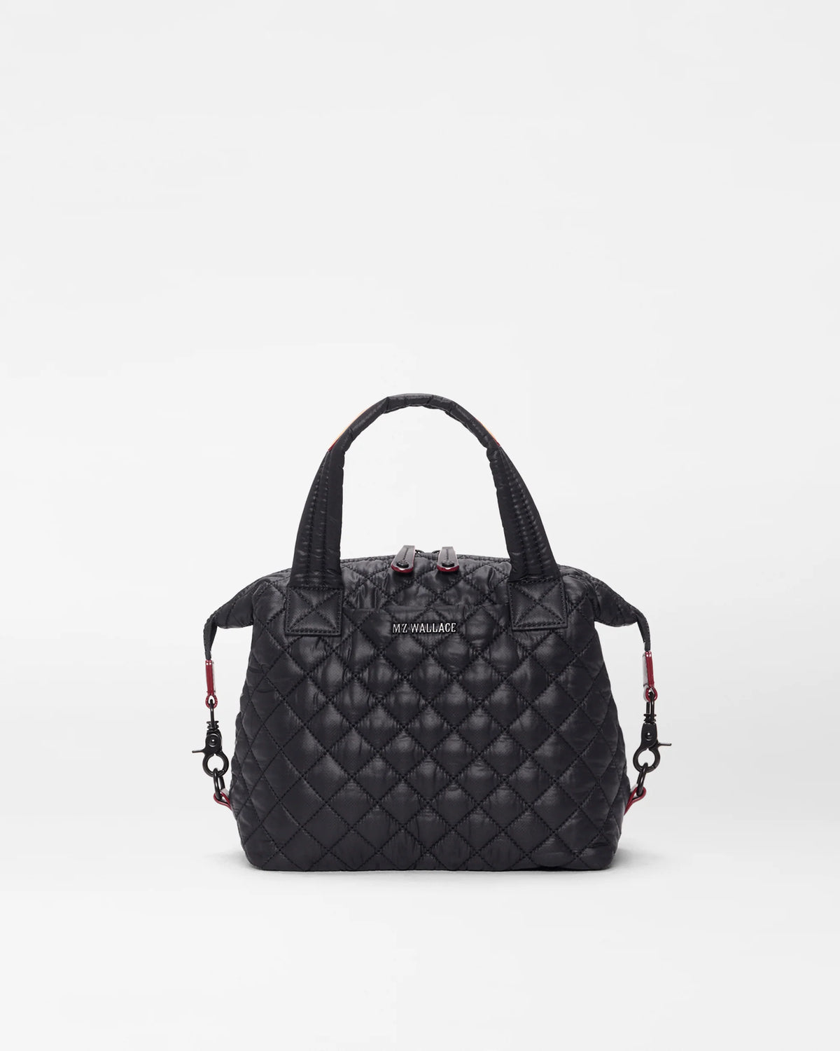 Black quilted handbag on a light gray background