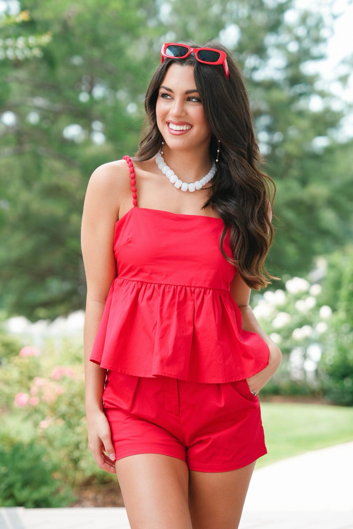 girl wearing matching red set outside