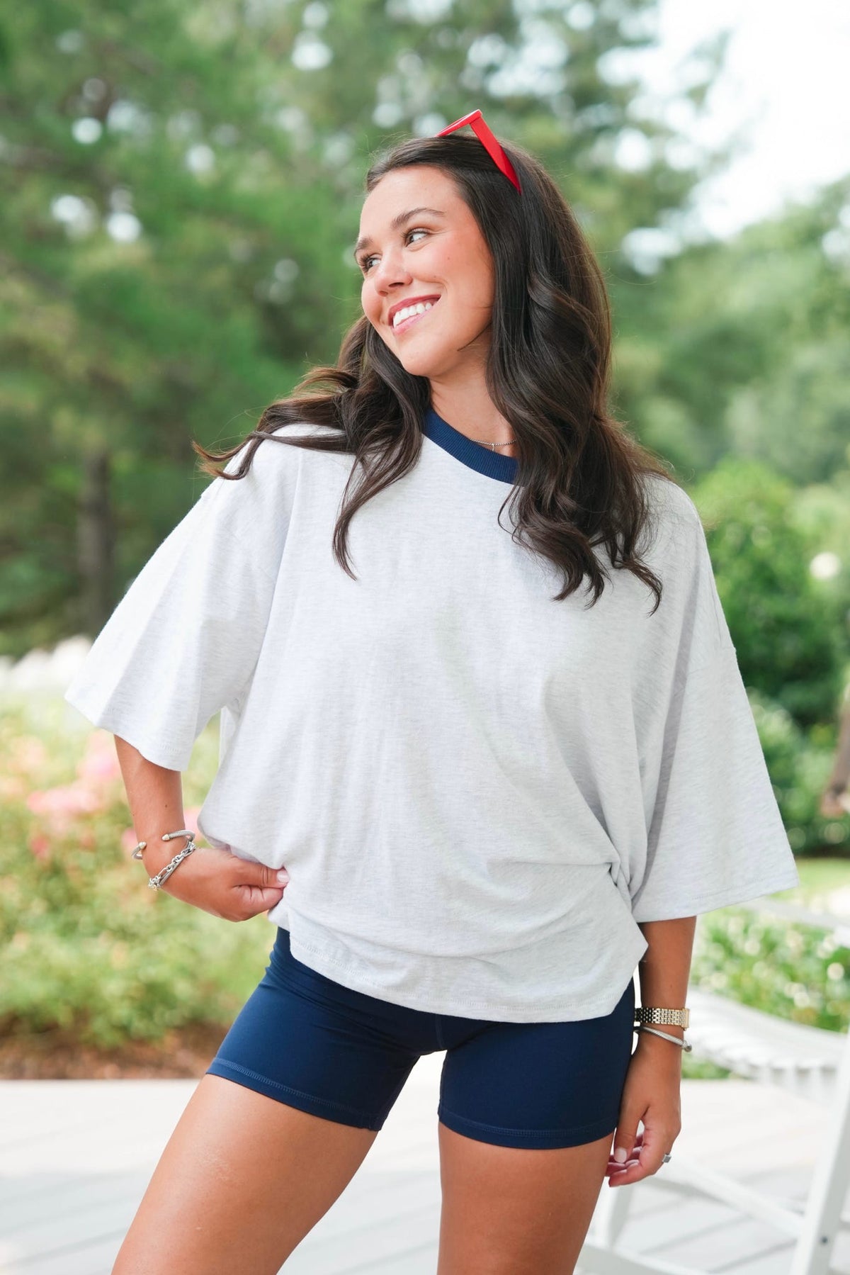girl wearing a grey shirt and navy shorts