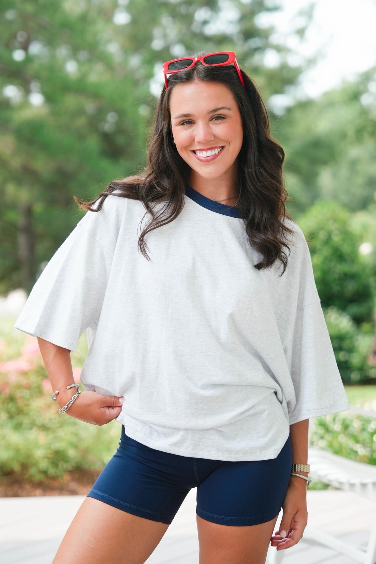 girl wearing a grey shirt and navy shorts