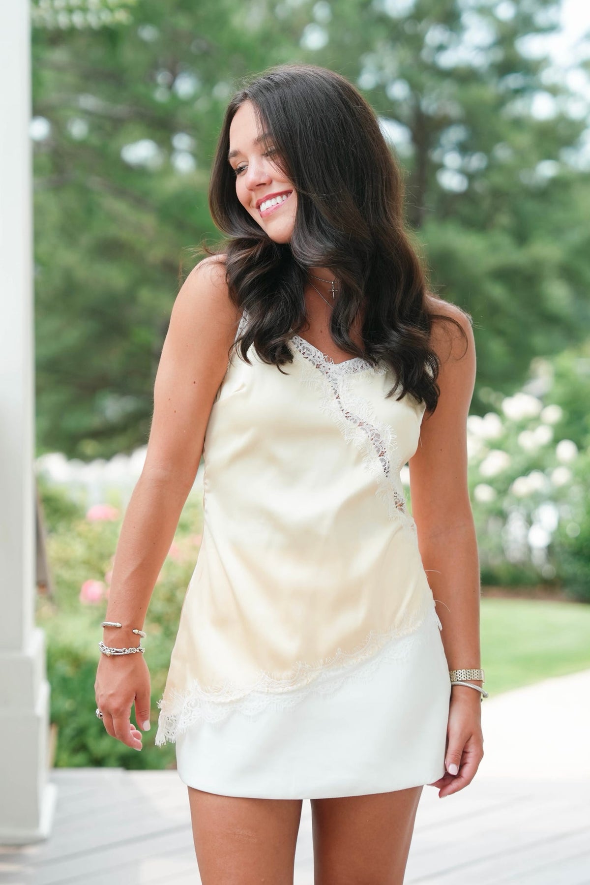 Woman wearing a yellow lace top and white skirt