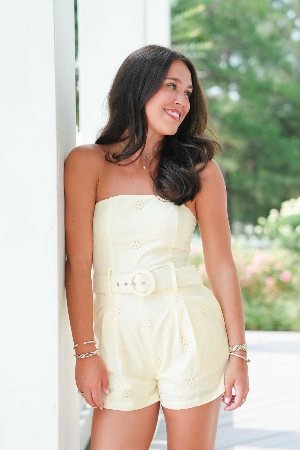 girl wearing a yellow eyelet romper