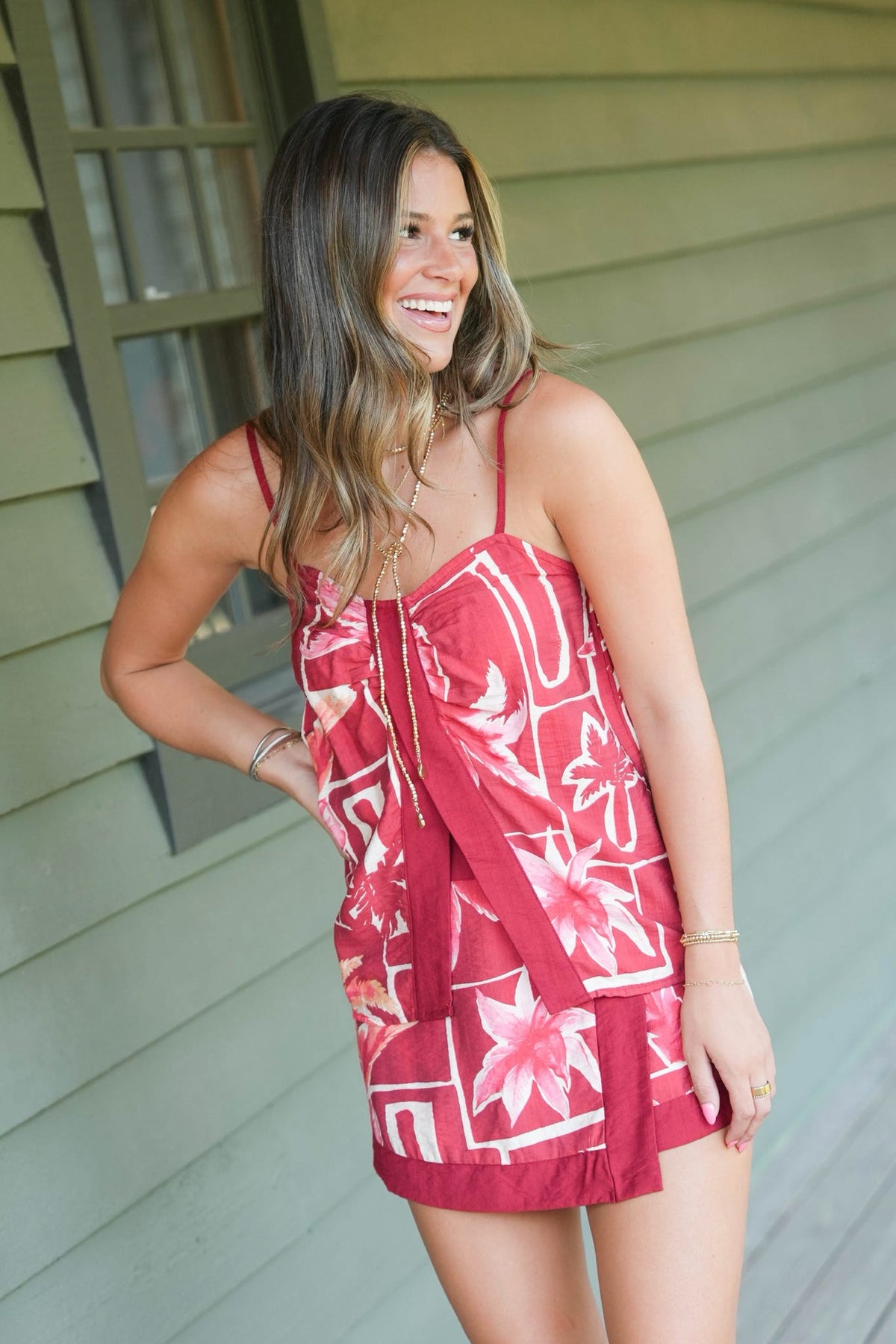 Girl in burgundy floral set with knee high cream boots