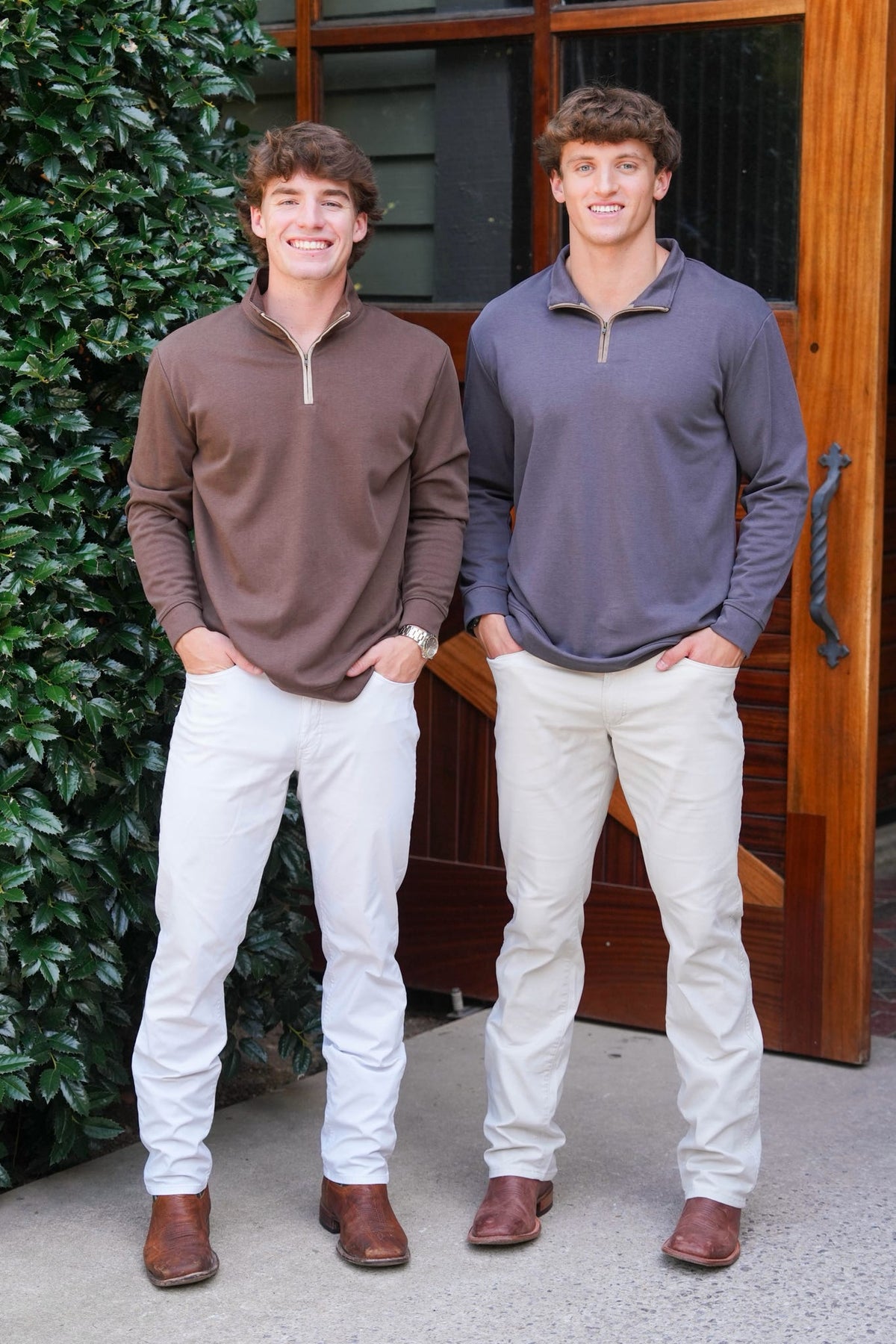 Two men modeling a quarter zip with khaki pants and cowboy boots