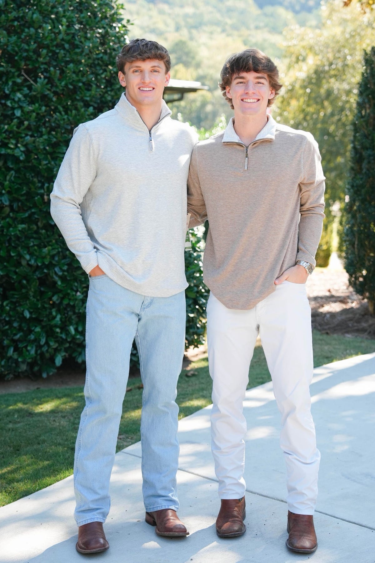 two young men in heathered quarter zips outdoors 