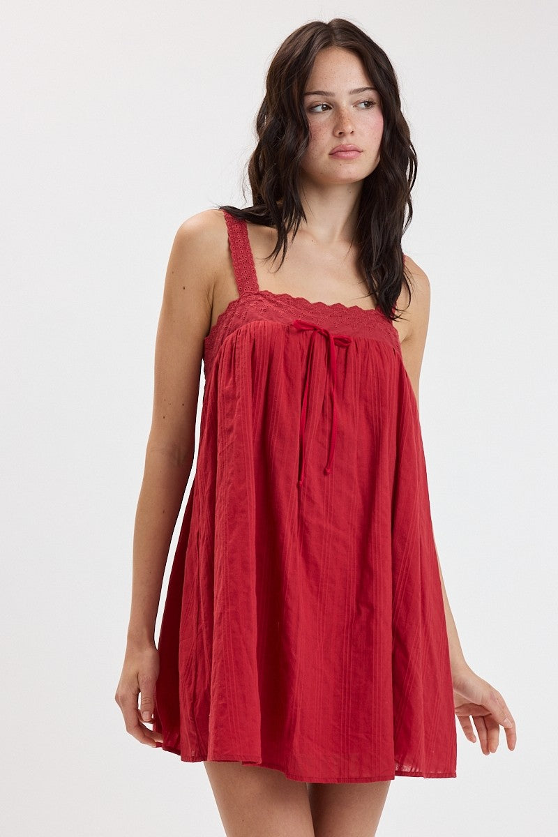 Woman wearing a red dress on a white background