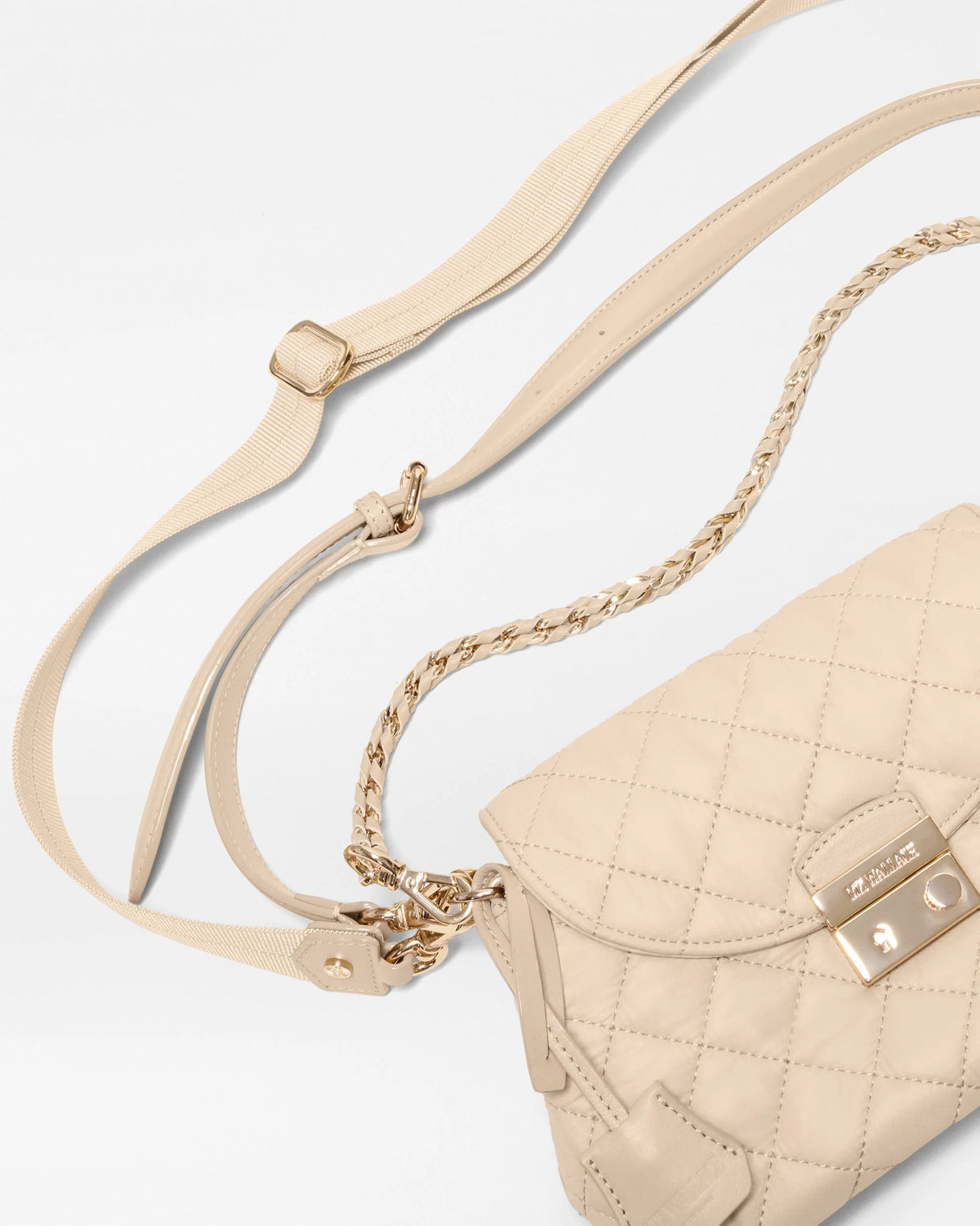 Beige quilted leather shoulder bag with a gold-tone turn-lock clasp and a gold chain strap, shown on a clean white background.
