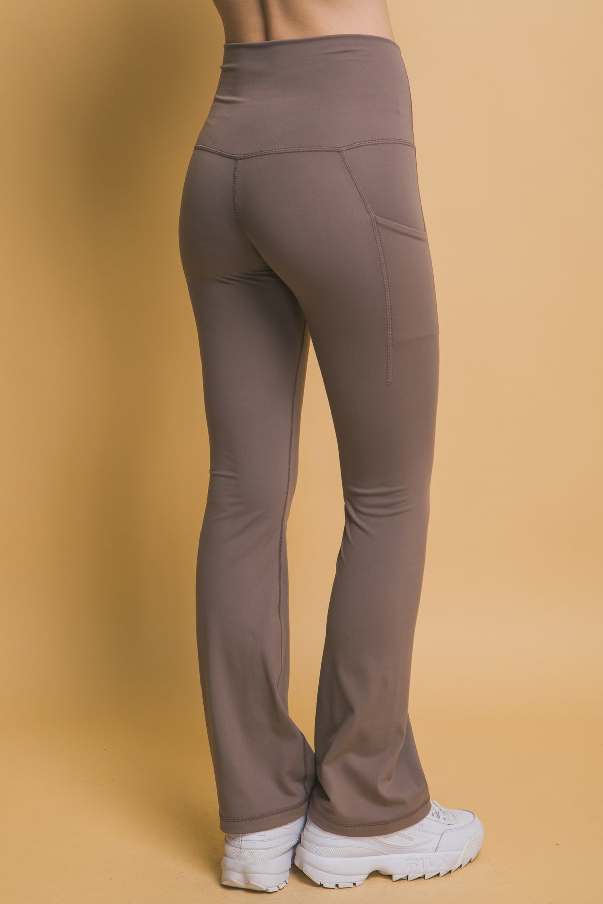 woman modeling taupe yoga pants