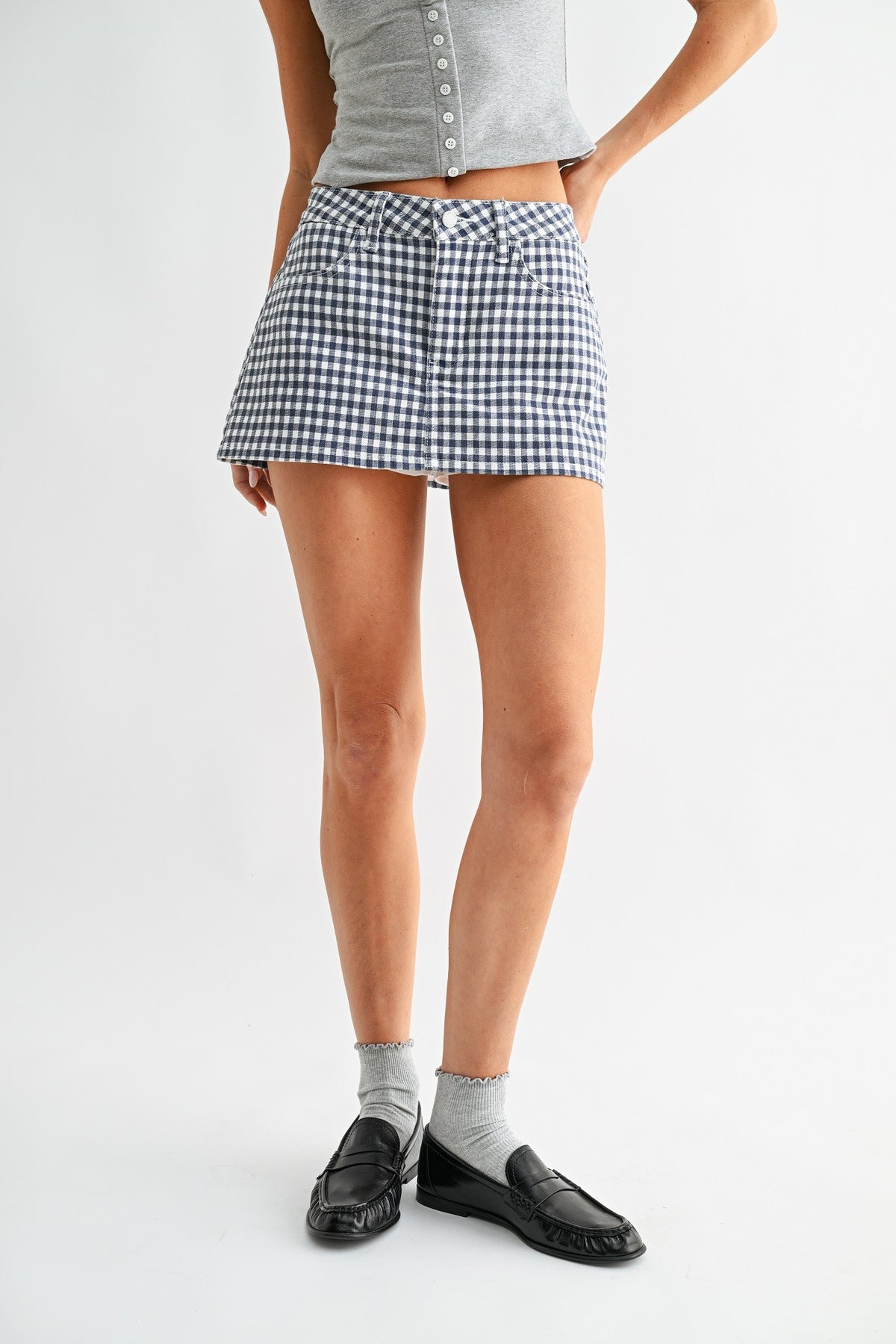Person wearing a checkered skirt on a white background