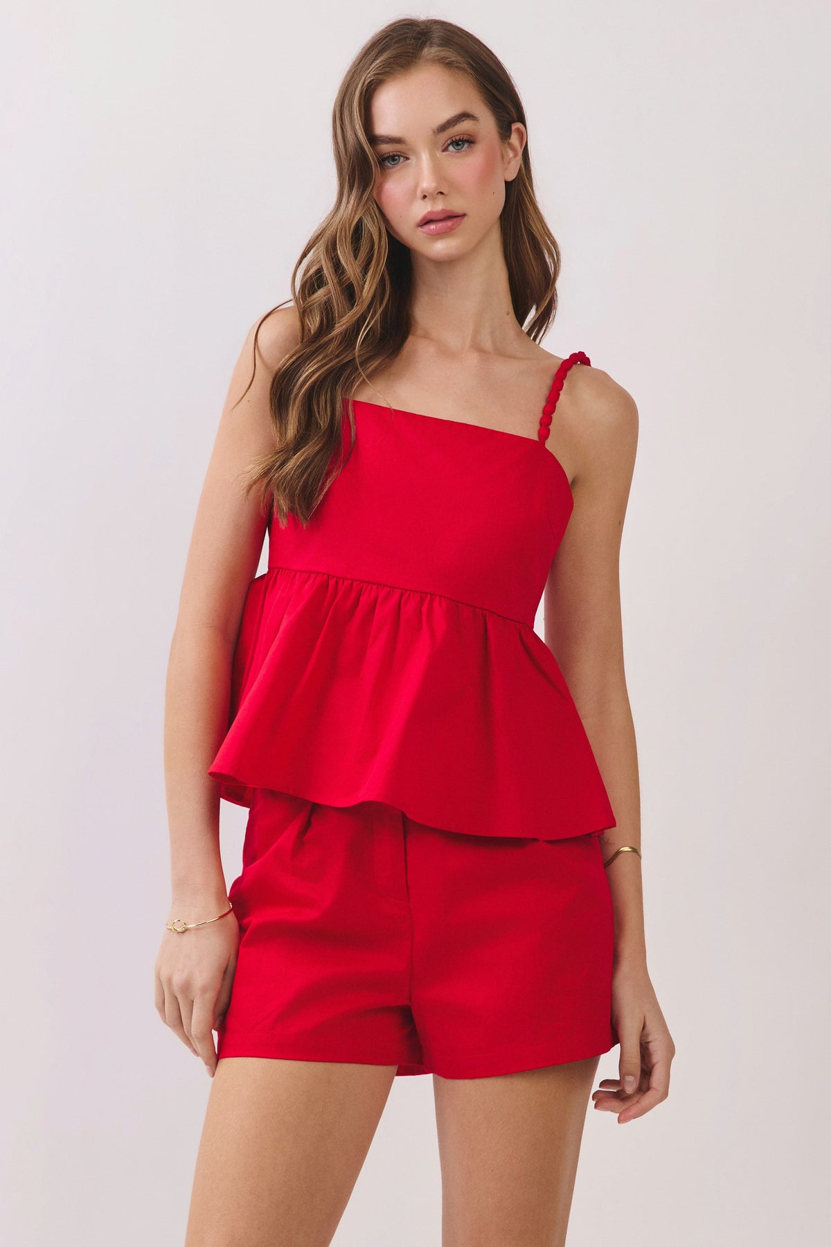 girl wearing red top with beaded straps