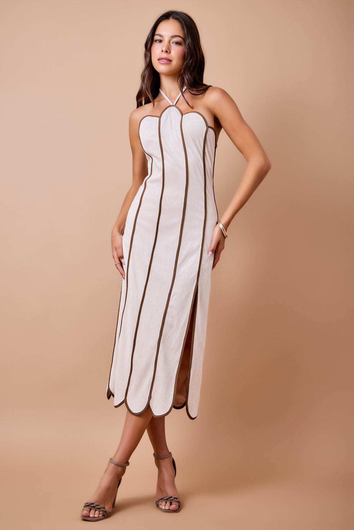 woman modeling a scalloped color block dress with halter neckline