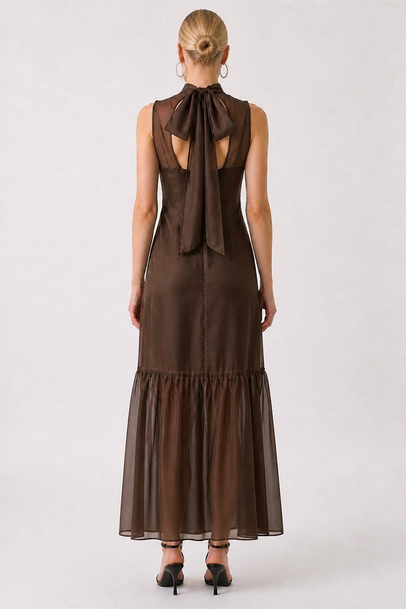 Brown dress with a bow detail on the back, worn by a person on a white background