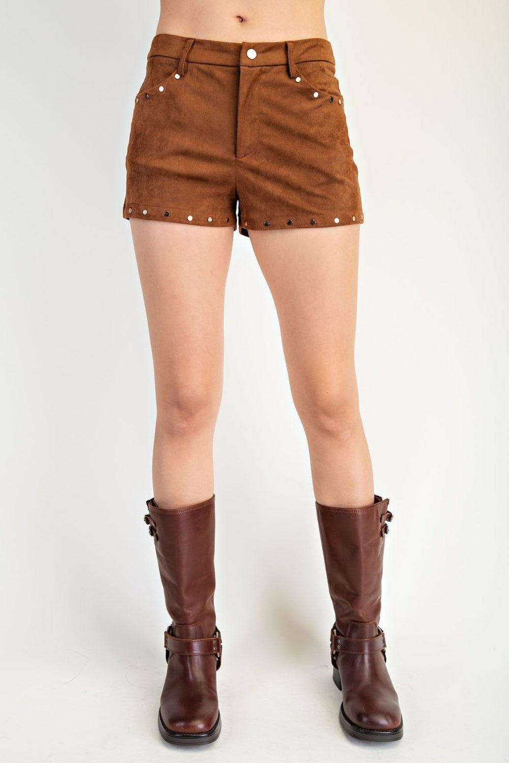 Brown suede shorts with studded details worn by a person on a white background