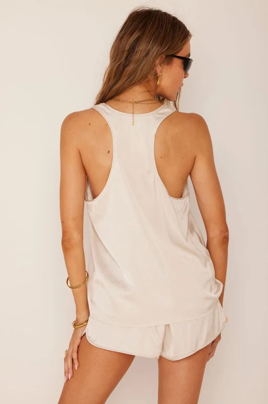 woman modeling white tank top and shorts on white background