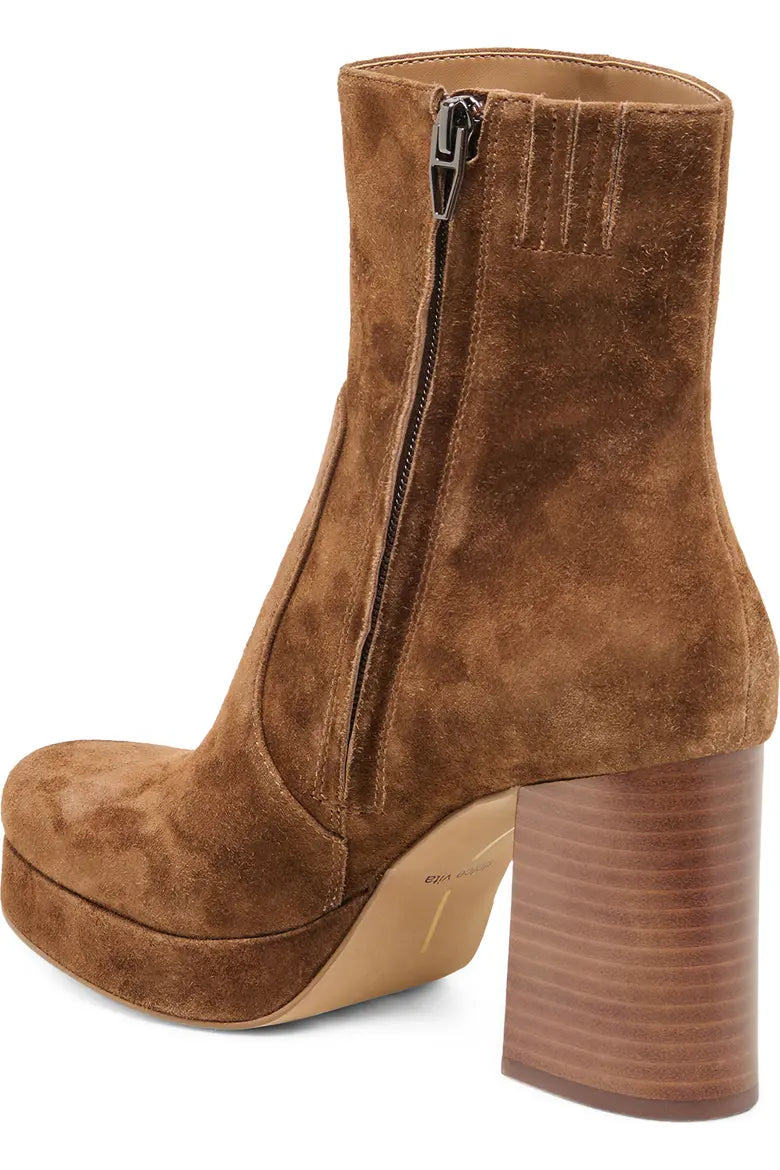 A brown suede ankle boot with a high block heel, platform sole, and side zipper, shown from a three-quarters rear angle on a white background.