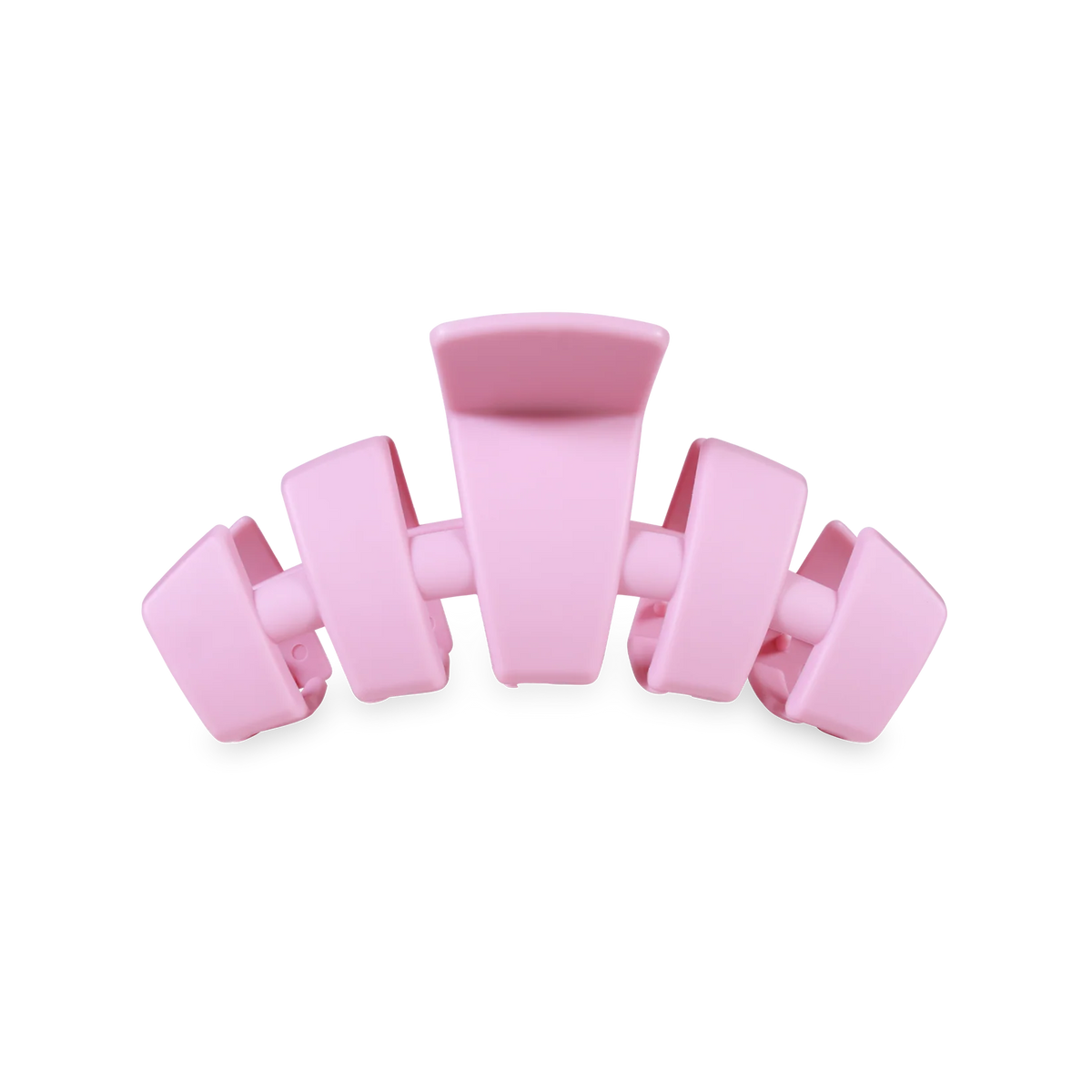 A light pink plastic claw hair clip shown from the side against a plain white background.