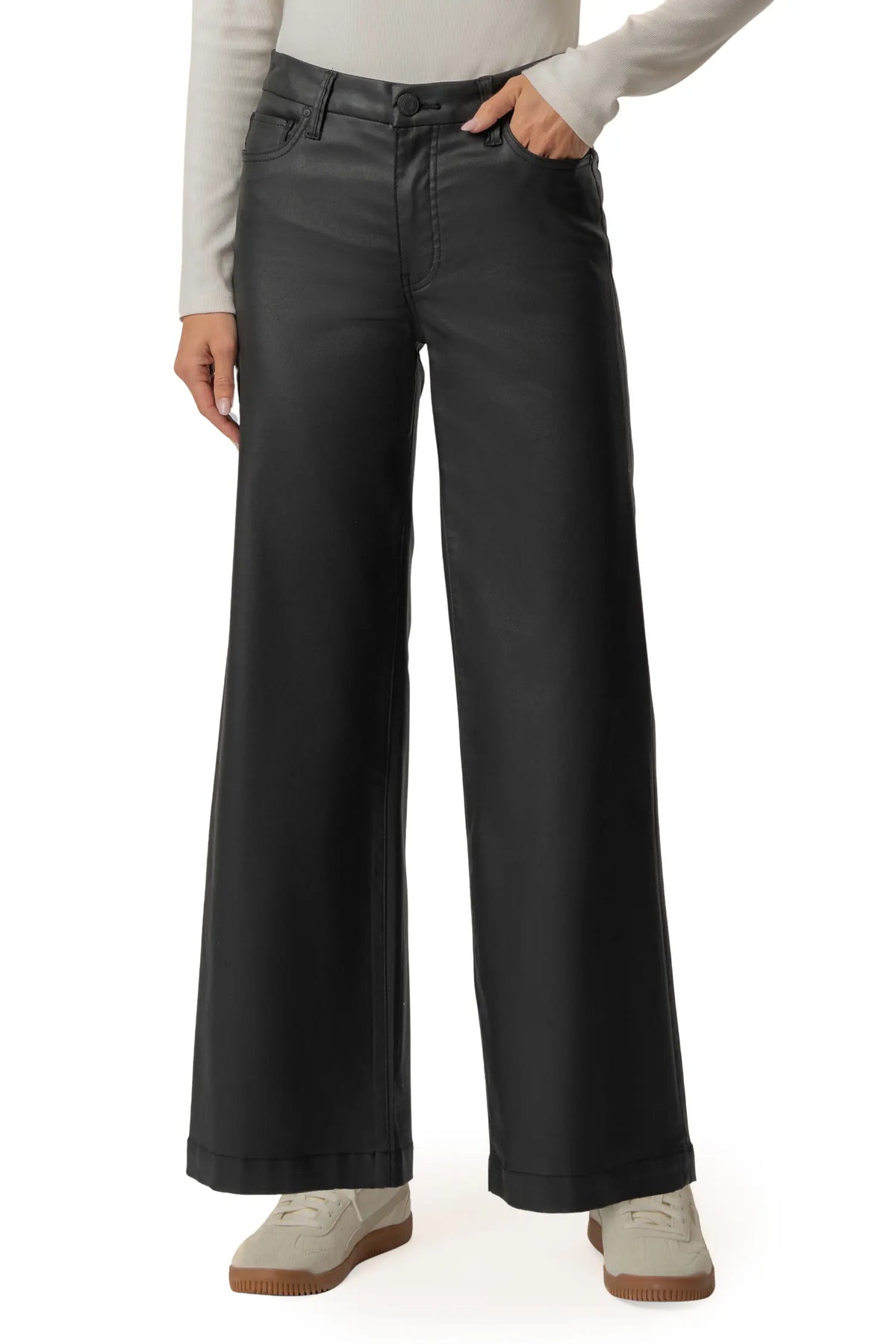 A model wearing a pair of black wide-leg cropped pants, styled with a light gray long-sleeve top and beige sneakers, against a plain white background.