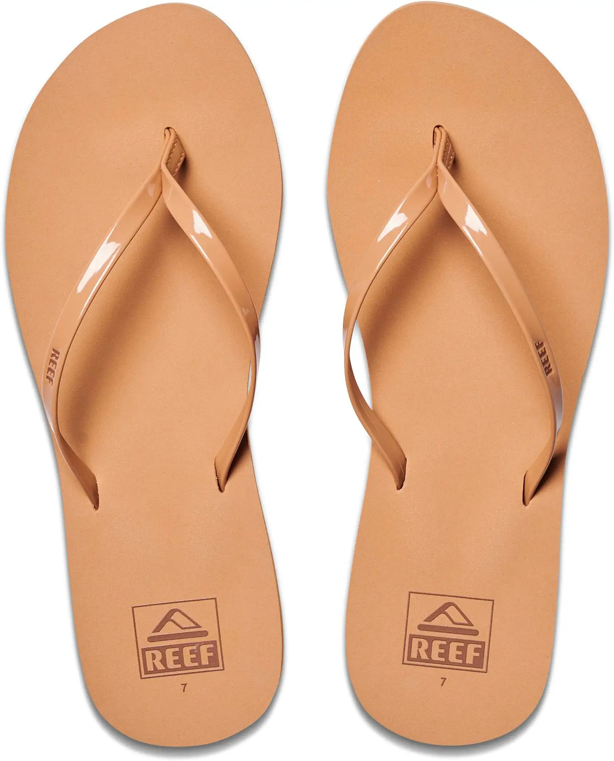 A pair of tan leather Reef flip-flops shown from a top-down view on a white background.