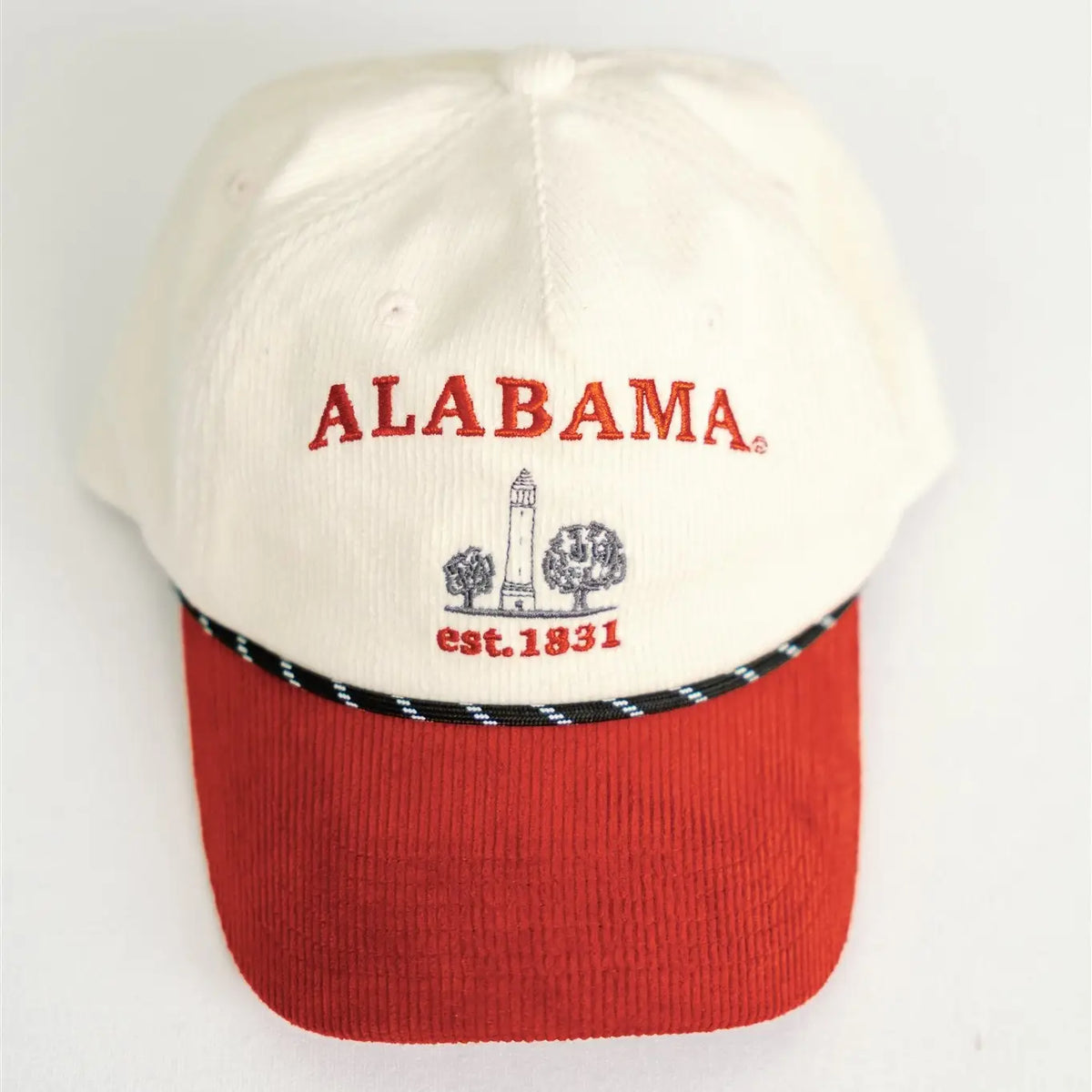 An Alabama baseball cap with an off-white crown, red corduroy visor, and red embroidered 'ALABAMA' text with a lighthouse graphic on the front.