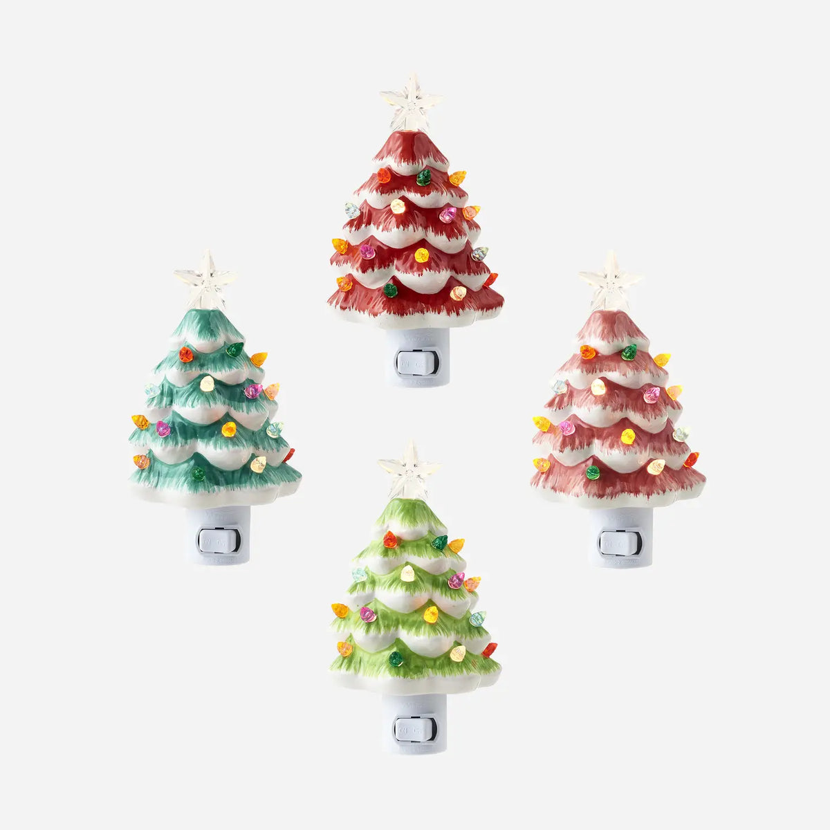 Four vintage-style Christmas tree night lights with white switch bases, shown on a light gray background. The trees are decorated in red, green, and pink with multicolored lights and white star toppers.