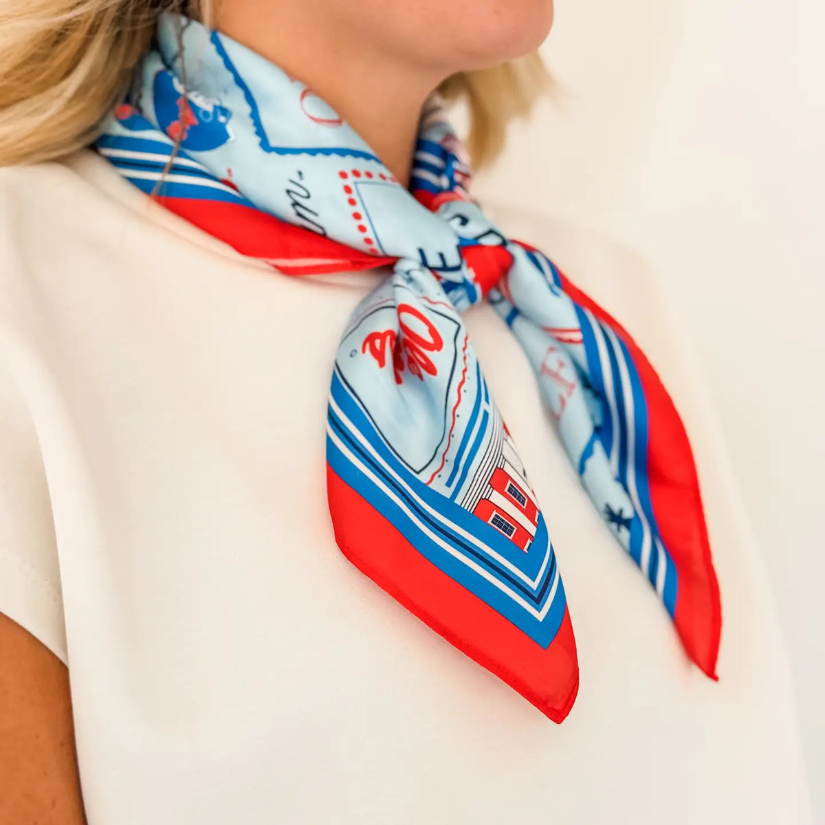 woman modeling a tied satin scarf around her neck as an accessory 