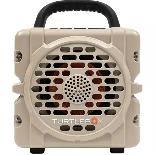 A beige portable speaker with a black carrying handle, featuring a circular front grille and the TurtleBox logo printed on the front.