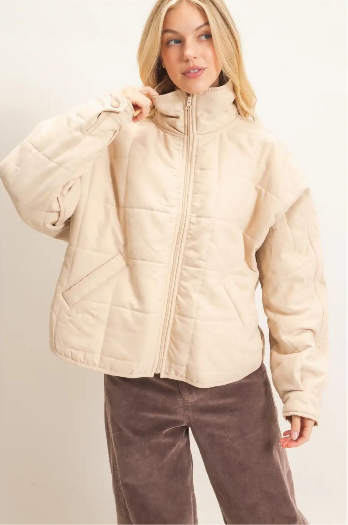 Woman wearing beige quilted jacket