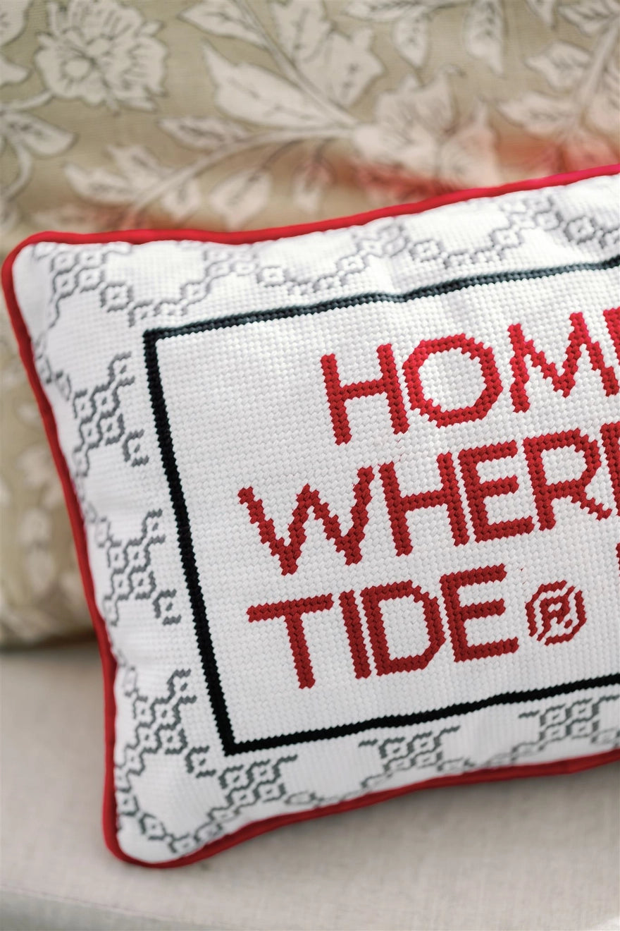 Cross-stitched pillow with 'Home is where the tide is' text on a floral background