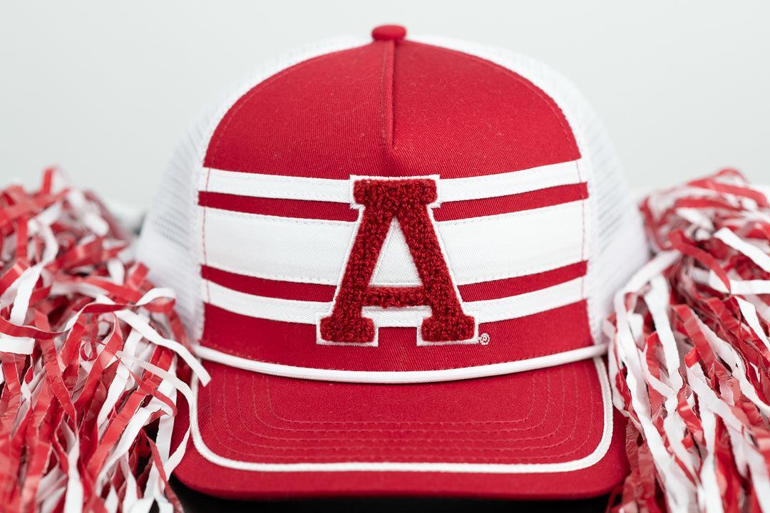 Red and white cap with a large letter 'A' on a white background