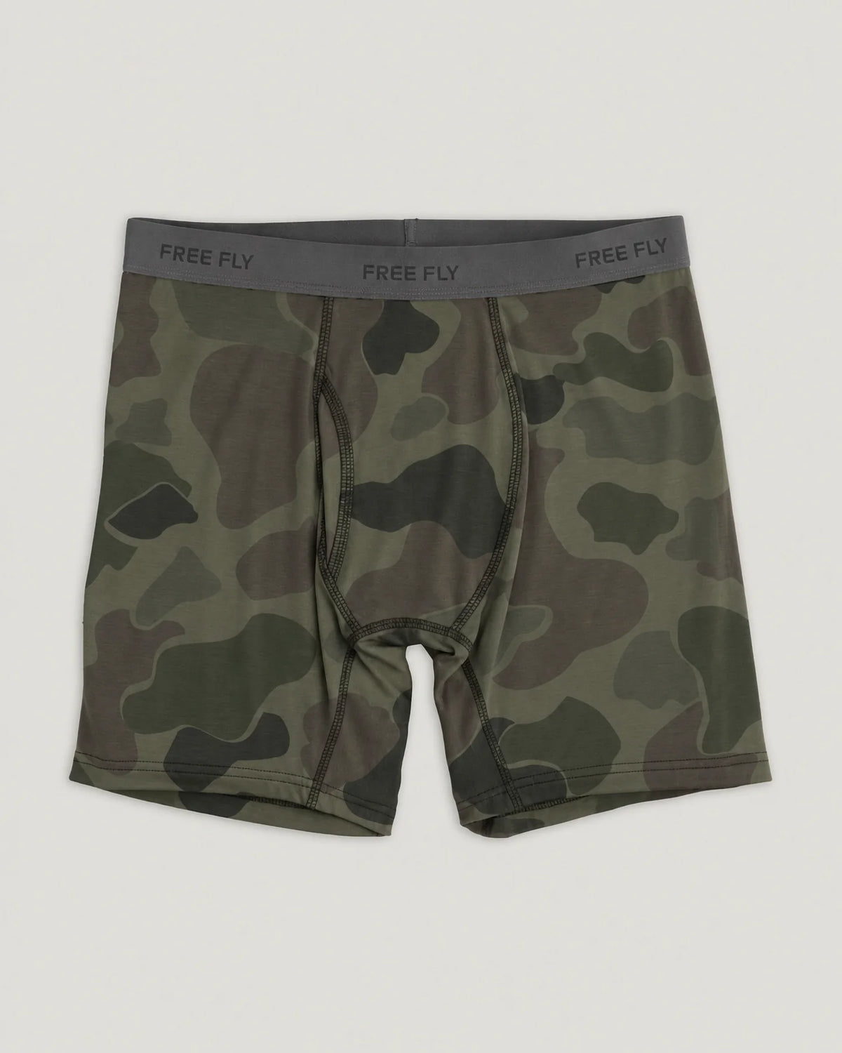 A pair of men's boxer briefs featuring a green and brown camouflage pattern with a dark gray elastic waistband printed with the brand name 'FREE FLY'.