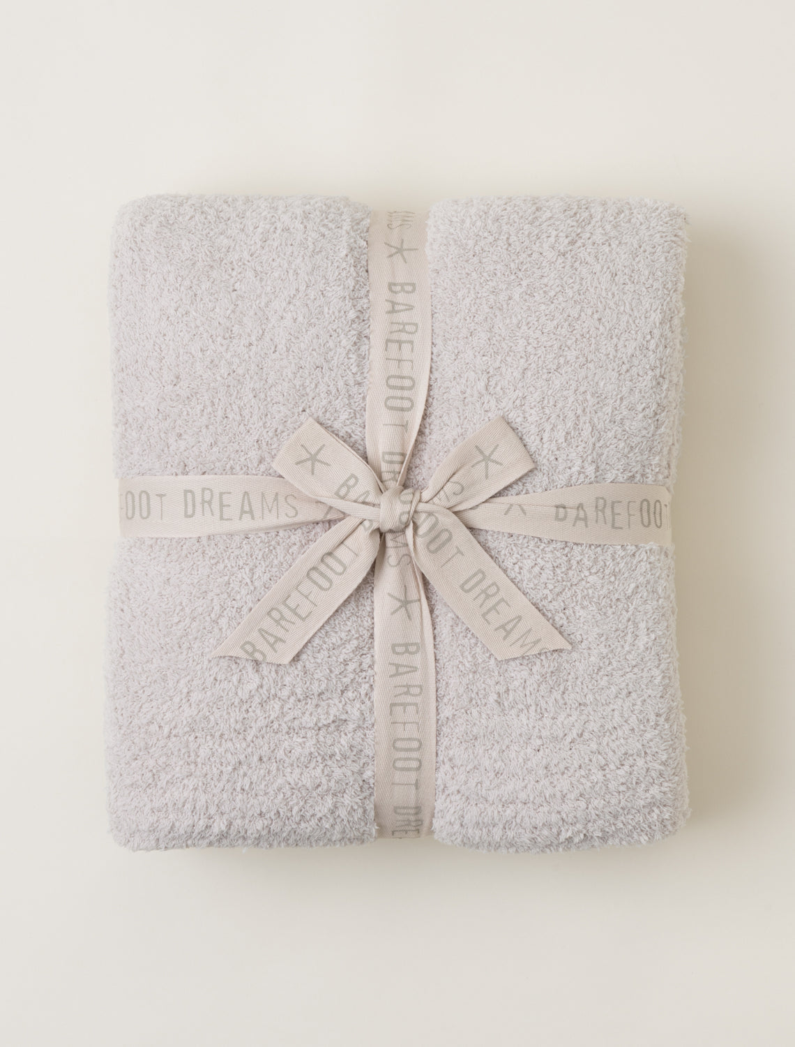Gray textured blanket with a ribbon on a white background